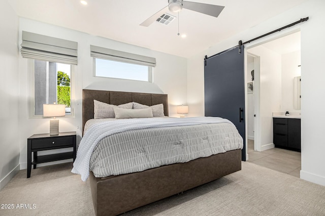 carpeted bedroom featuring multiple windows, a barn door, and ceiling fan