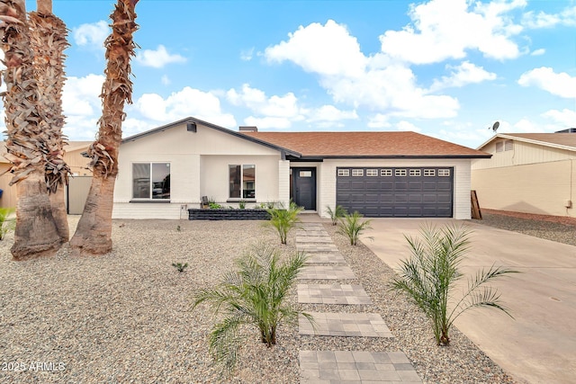 view of front facade with brick siding, an attached garage, and concrete driveway