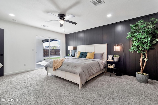 carpeted bedroom with visible vents, baseboards, a ceiling fan, and access to outside