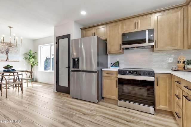 kitchen featuring stainless steel appliances, light brown cabinetry, decorative backsplash, and light countertops