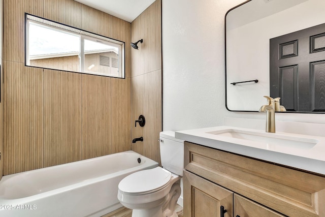 full bath featuring bathtub / shower combination, toilet, and vanity