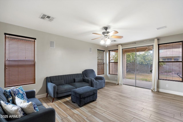 living room with ceiling fan and light wood-type flooring