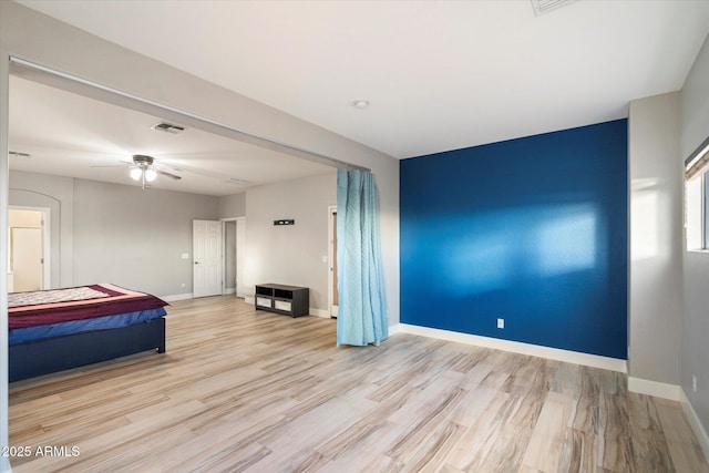 unfurnished bedroom featuring ceiling fan and light wood-type flooring