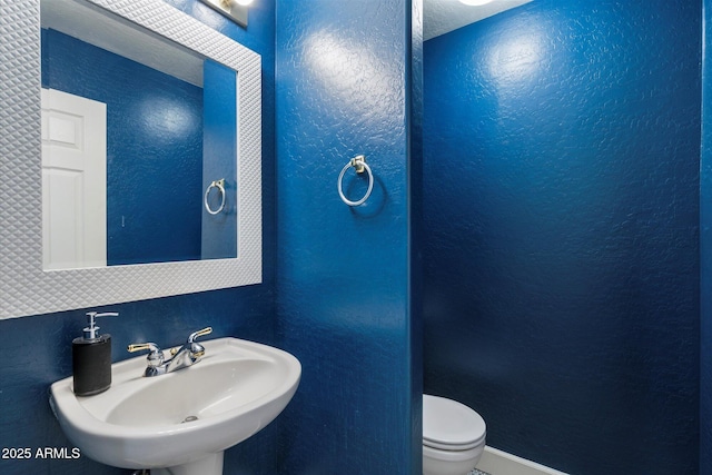 bathroom featuring sink and toilet