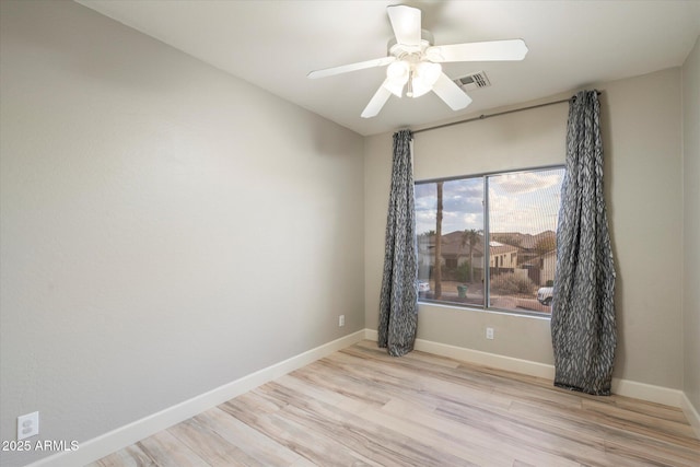 empty room with ceiling fan and light wood-type flooring