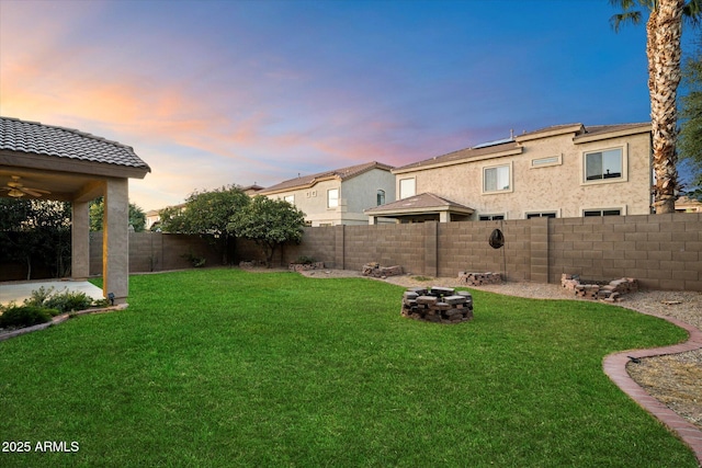 yard at dusk with a fire pit