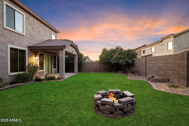 yard at dusk with a fire pit and a patio