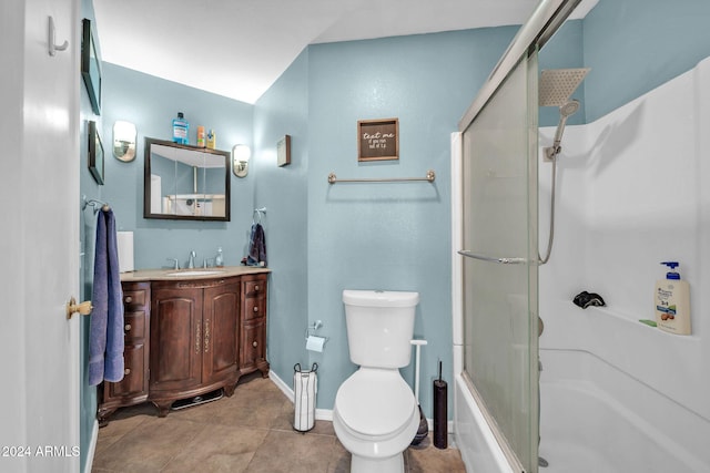 bathroom with tile patterned flooring, vanity, toilet, and walk in shower