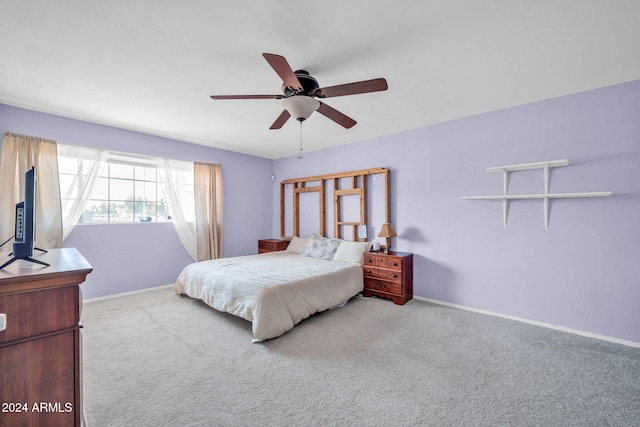 bedroom with ceiling fan and light colored carpet