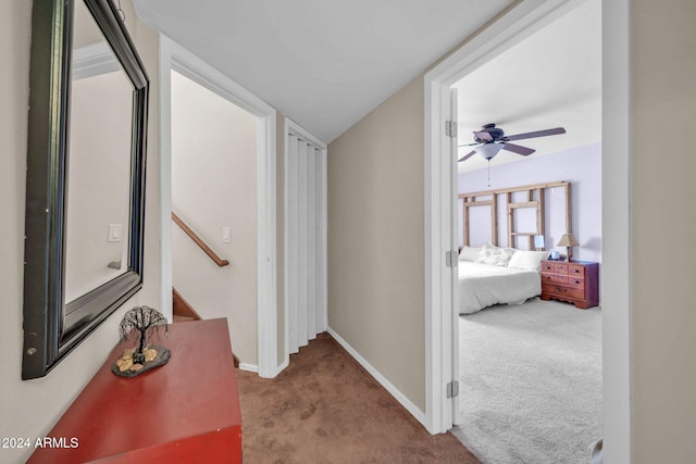 hallway featuring carpet and vaulted ceiling