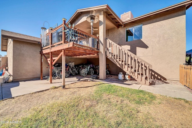 rear view of house featuring a patio, ceiling fan, and a wooden deck