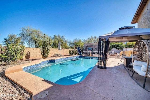 view of swimming pool with a gazebo and a patio