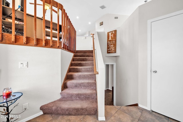 stairway with tile patterned floors