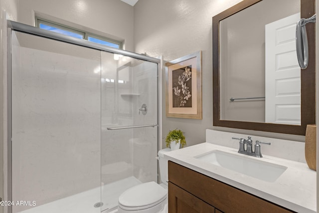 full bath featuring toilet, a shower stall, and vanity