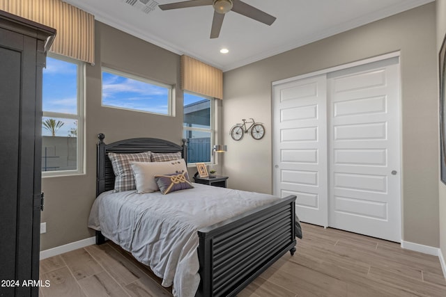 bedroom featuring ornamental molding, visible vents, light wood-style flooring, and baseboards