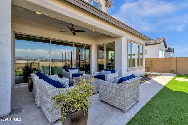 view of patio with ceiling fan, fence, and an outdoor living space