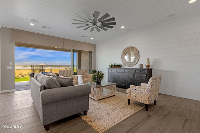 living room featuring recessed lighting, visible vents, crown molding, and wood finished floors