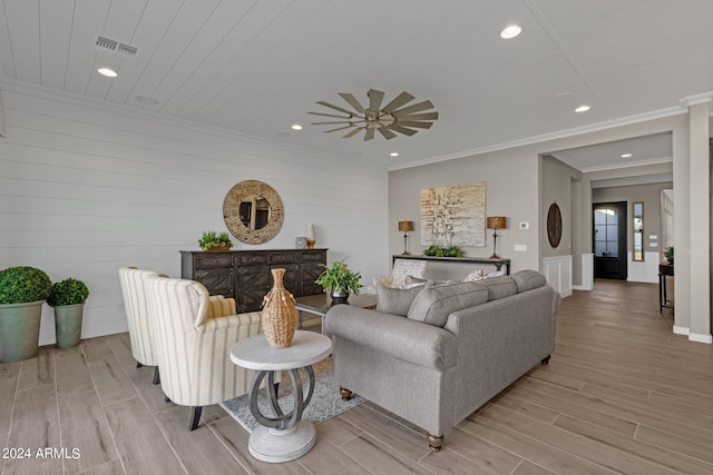 living area featuring ornamental molding, recessed lighting, visible vents, and light wood-style floors