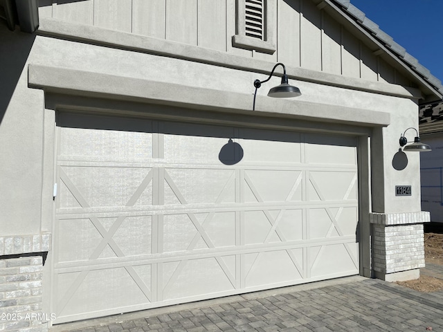 garage with decorative driveway