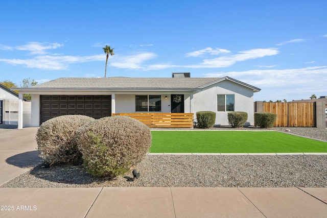 ranch-style house featuring stucco siding, concrete driveway, a front yard, fence, and a garage