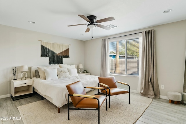 bedroom featuring light wood-type flooring, ceiling fan, and baseboards