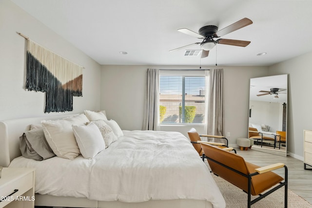 bedroom featuring light wood-type flooring, baseboards, visible vents, and recessed lighting