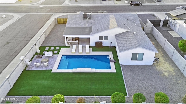 view of pool featuring a patio and a yard