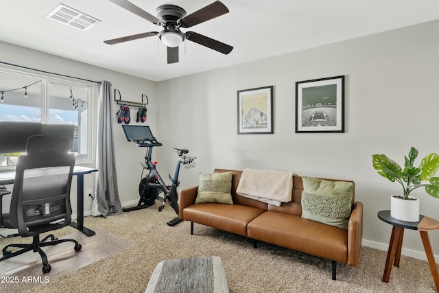 home office featuring light carpet, baseboards, visible vents, and a ceiling fan