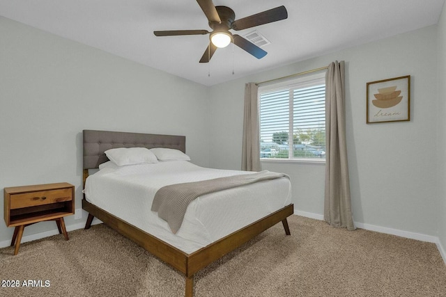 carpeted bedroom with a ceiling fan and baseboards