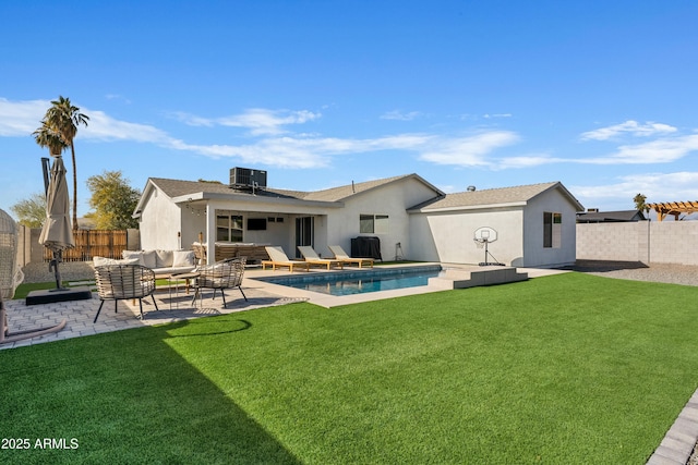 rear view of property featuring a lawn, a fenced in pool, a fenced backyard, an outdoor hangout area, and central AC