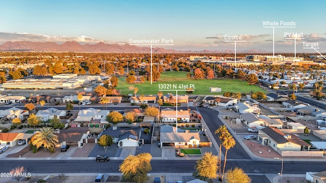 aerial view at dusk featuring a mountain view