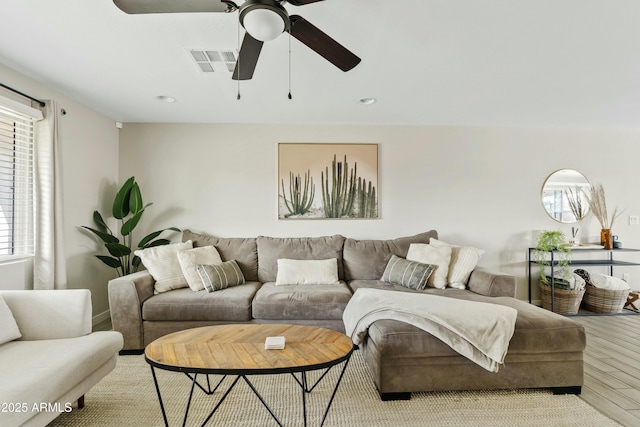 living room with ceiling fan and light wood-type flooring