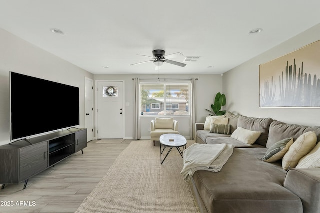 living room with ceiling fan and light hardwood / wood-style flooring