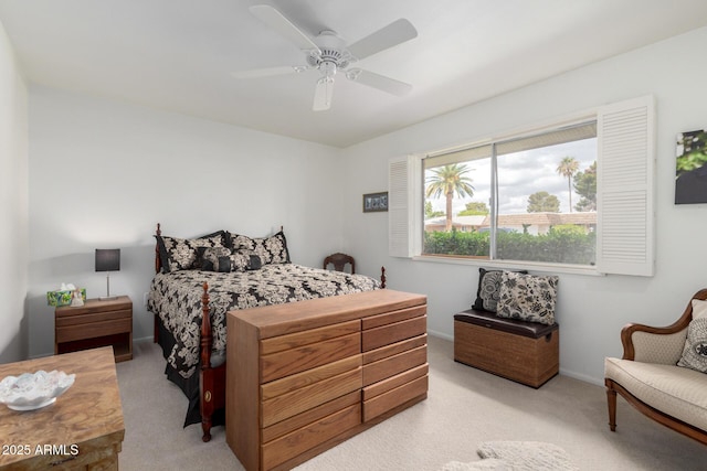 bedroom featuring light colored carpet, baseboards, and ceiling fan