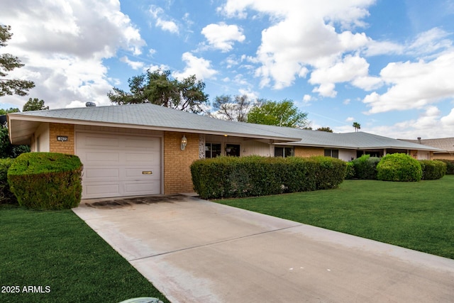 single story home featuring a front yard, an attached garage, brick siding, and driveway