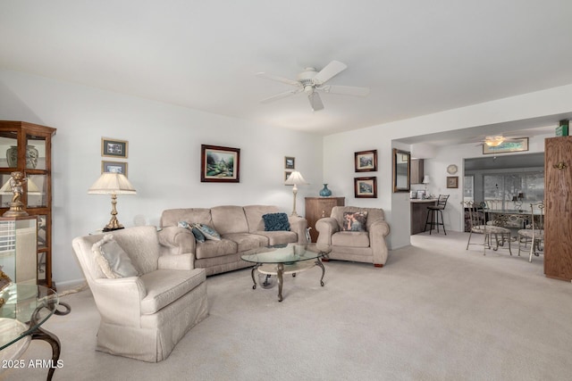 carpeted living area featuring ceiling fan