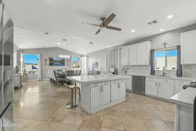 kitchen featuring pendant lighting, a center island, and white cabinetry