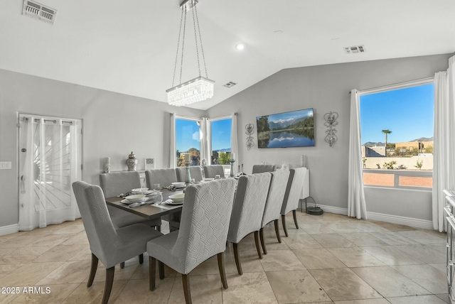 dining area featuring a chandelier and lofted ceiling