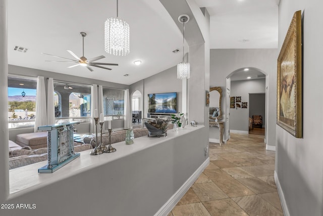 hallway with a chandelier and lofted ceiling