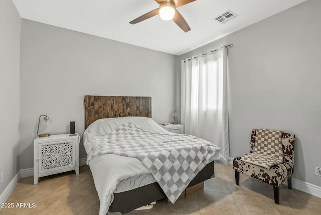 bedroom with ceiling fan and light tile patterned floors