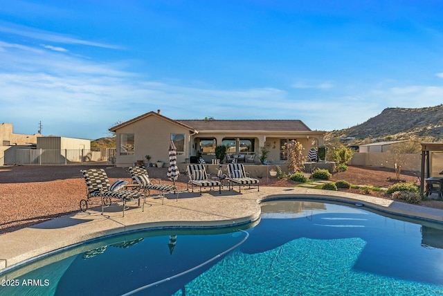 view of pool featuring a patio area and a mountain view