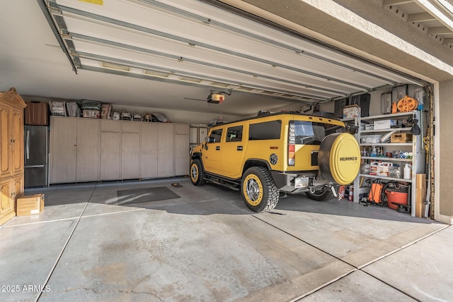 garage featuring stainless steel refrigerator and a garage door opener