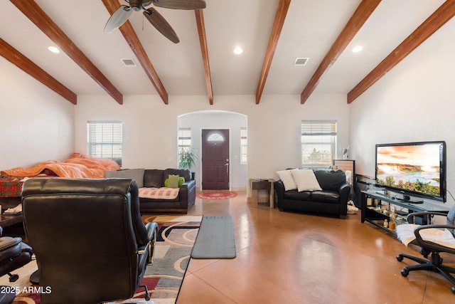 living room with finished concrete flooring, visible vents, arched walkways, and recessed lighting