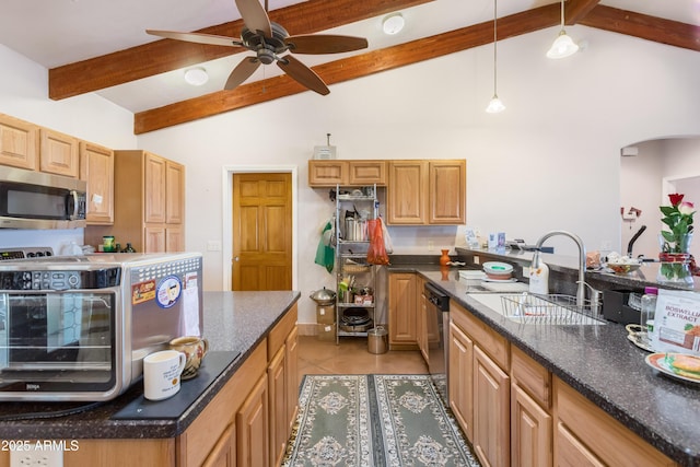 kitchen featuring light tile patterned floors, a sink, a ceiling fan, hanging light fixtures, and appliances with stainless steel finishes