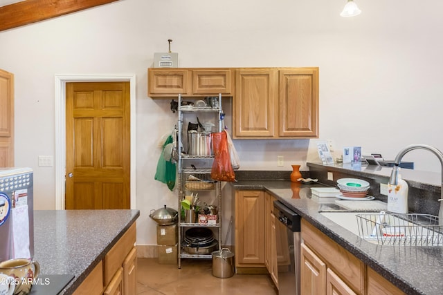 kitchen featuring light tile patterned floors, dark stone counters, dishwasher, lofted ceiling, and a sink