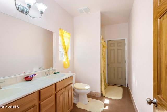 bathroom with toilet, double vanity, visible vents, and a sink