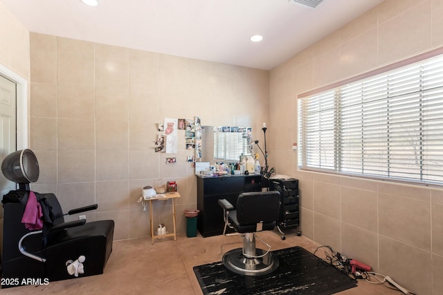 interior space featuring visible vents, tile walls, and recessed lighting