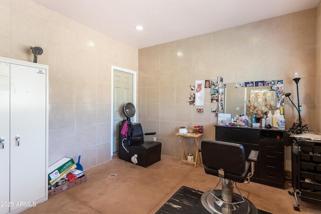 office with tile walls and recessed lighting