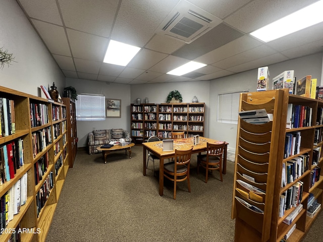 carpeted office with a paneled ceiling