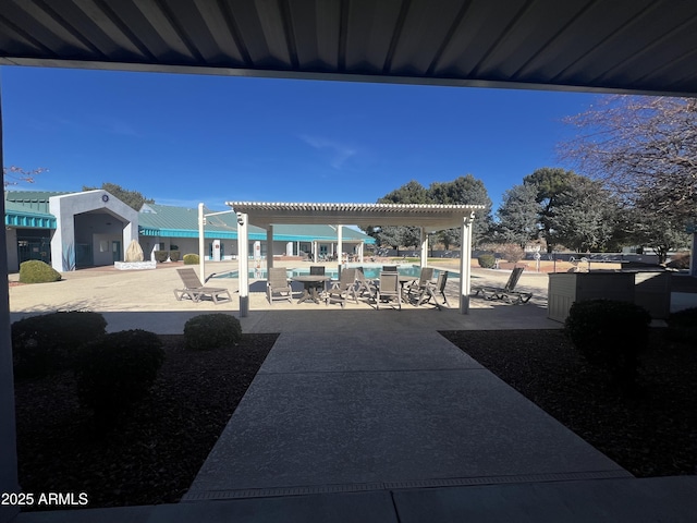 view of patio / terrace featuring a community pool and a pergola